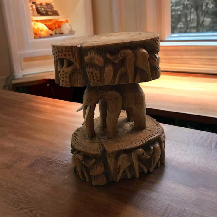 Close-up view of the Antique African Hand Carved Wooden Elephant Stool, showcasing the intricate woodwork and lifelike elephant design.
