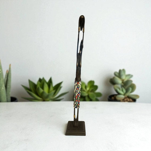 Decorative brooch on a stand with succulents in the background