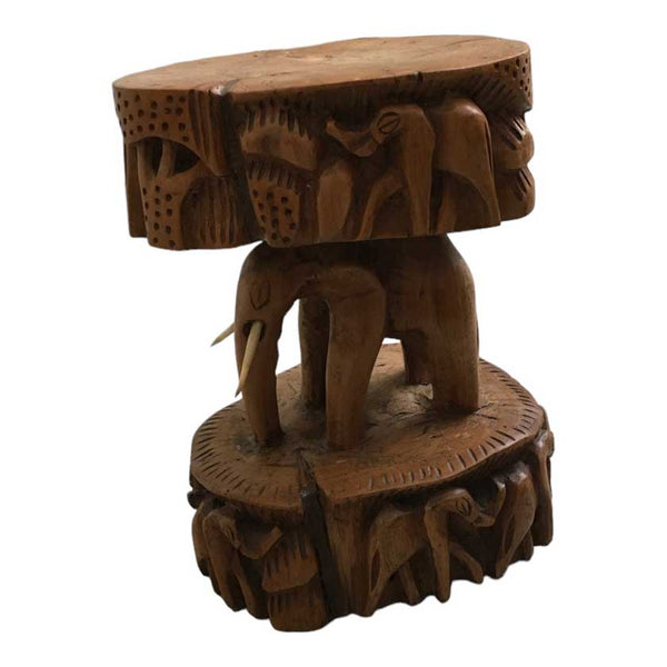 Close-up view of the Antique African Hand Carved Wooden Elephant Stool, showcasing the intricate woodwork and lifelike elephant design.