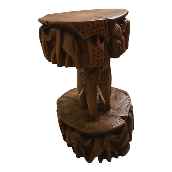 Close-up view of the Antique African Hand Carved Wooden Elephant Stool, showcasing the intricate woodwork and lifelike elephant design.