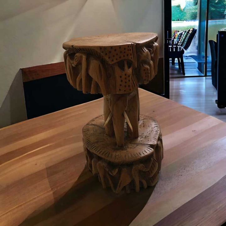 Close-up view of the Antique African Hand Carved Wooden Elephant Stool, showcasing the intricate woodwork and lifelike elephant design.