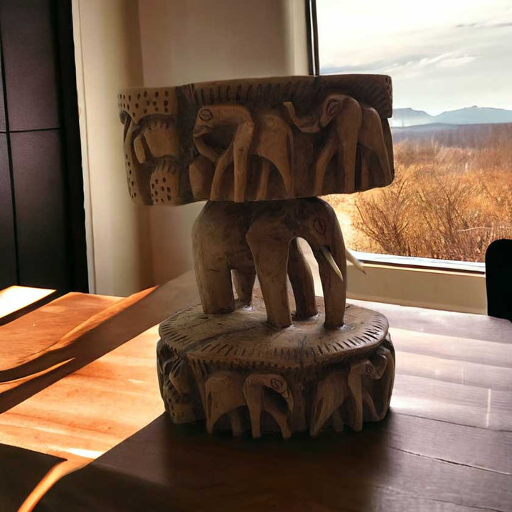 Close-up view of the Antique African Hand Carved Wooden Elephant Stool, showcasing the intricate woodwork and lifelike elephant design.