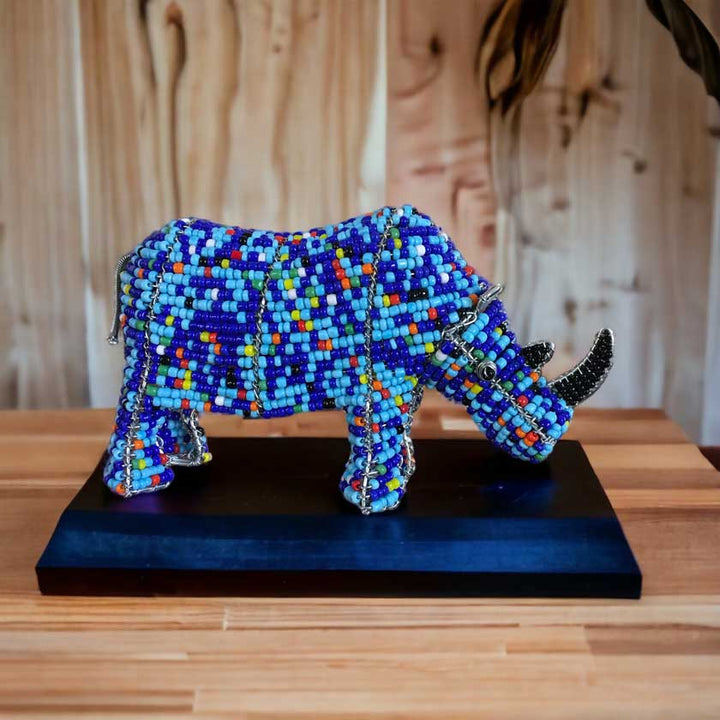 Vibrant handmade African bead and wire rhino sculpture, showcasing intricate craftsmanship and cultural significance, ideal for African art enthusiasts and home decor