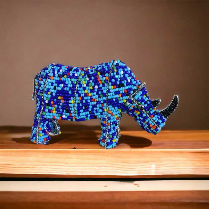 Vibrant handmade African bead and wire rhino sculpture, showcasing intricate craftsmanship and cultural significance, ideal for African art enthusiasts and home decor