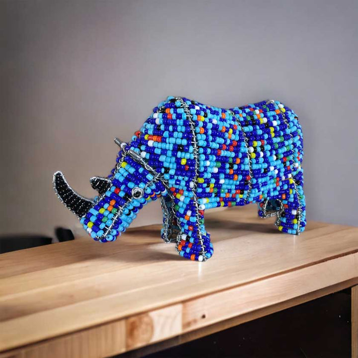 Vibrant handmade African bead and wire rhino sculpture, showcasing intricate craftsmanship and cultural significance, ideal for African art enthusiasts and home decor