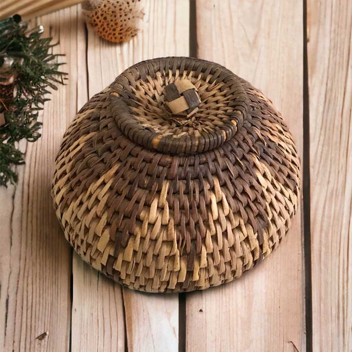 Beautifully handwoven African basket with a lid, showcasing intricate patterns and craftsmanship, a piece of African artistry for your home decor