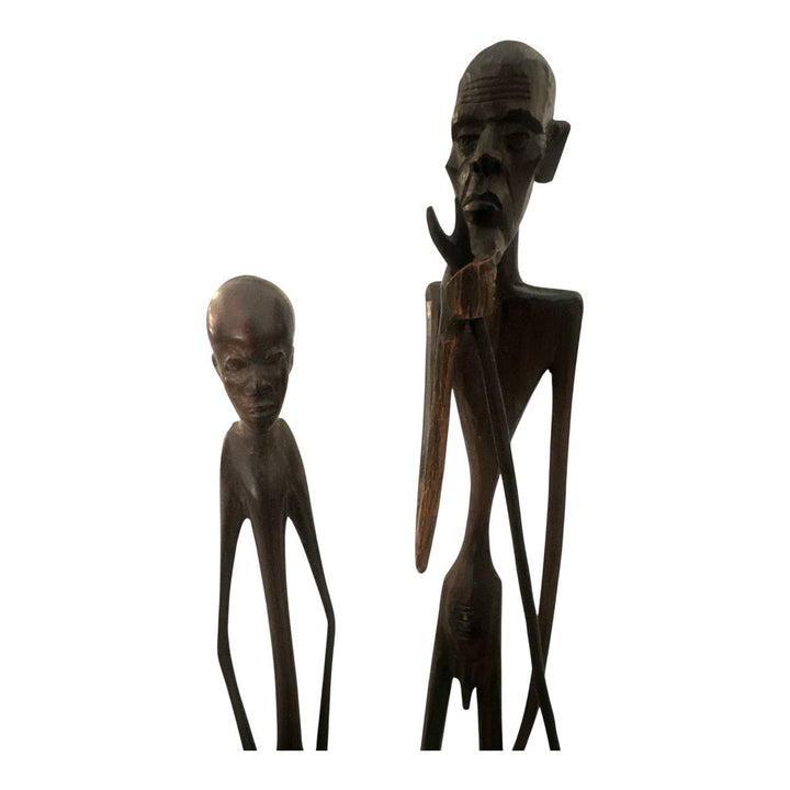 Two wooden figurines on a white background