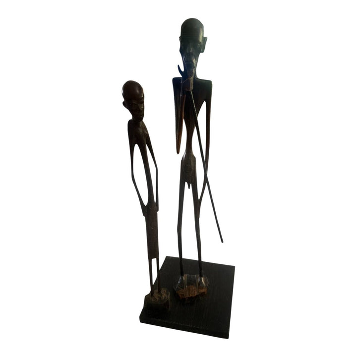 Sculpture of two figures on a white background