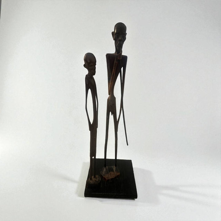 Sculpture of two figures on a white background