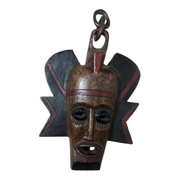Wooden mask with tribal design on a white background