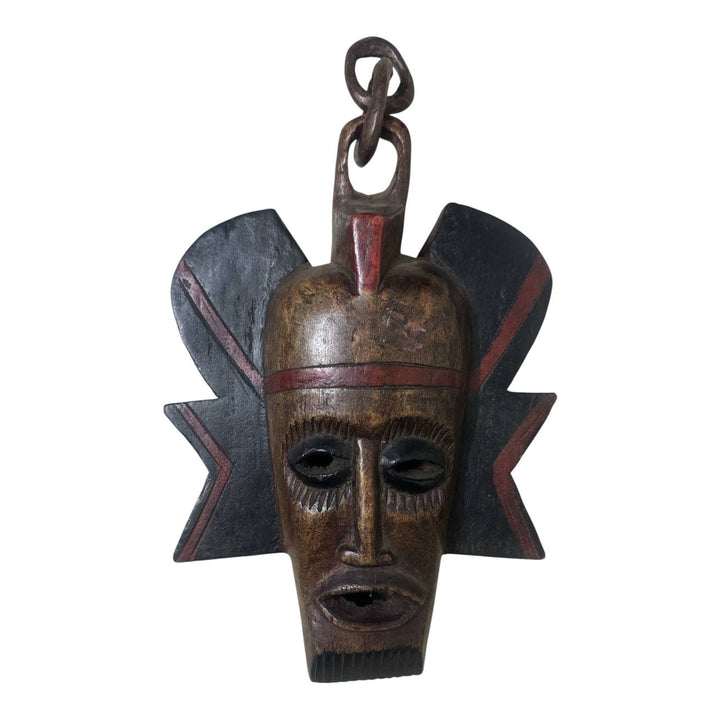 African-style wooden mask with a star-like design on a white background