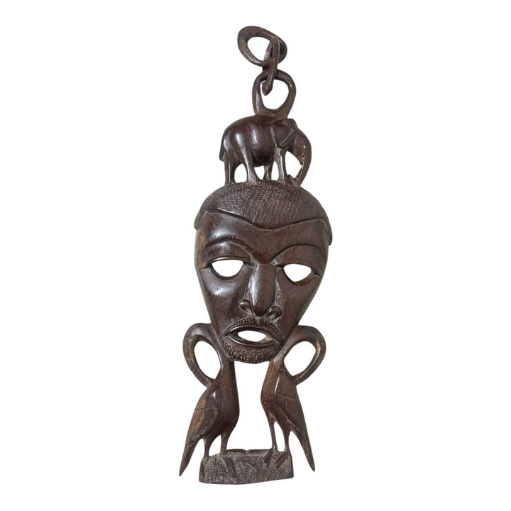 Decorative wooden mask with intricate carvings on a white background