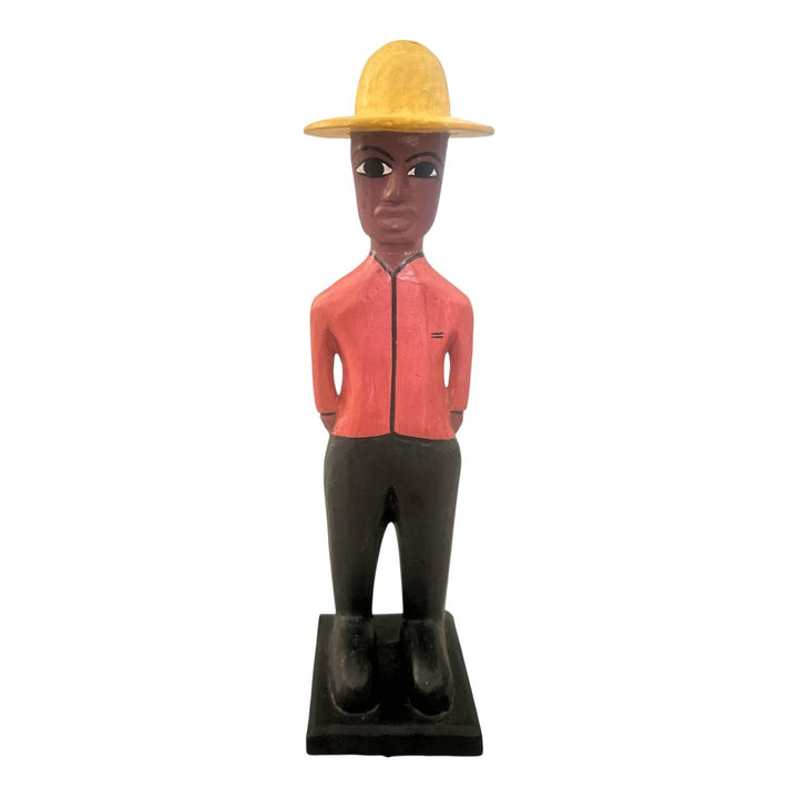 Bobblehead figure of a person wearing a red shirt and yellow hat on a white background