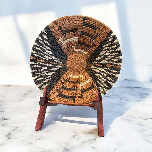 Decorative woven basket with geometric pattern on a marble surface