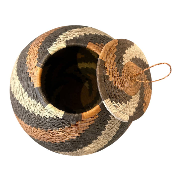 Woven basket with a lid on a white background