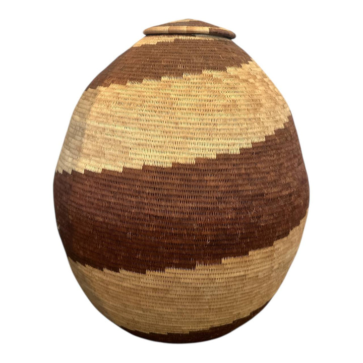 Woven basket with brown and beige pattern on a white background