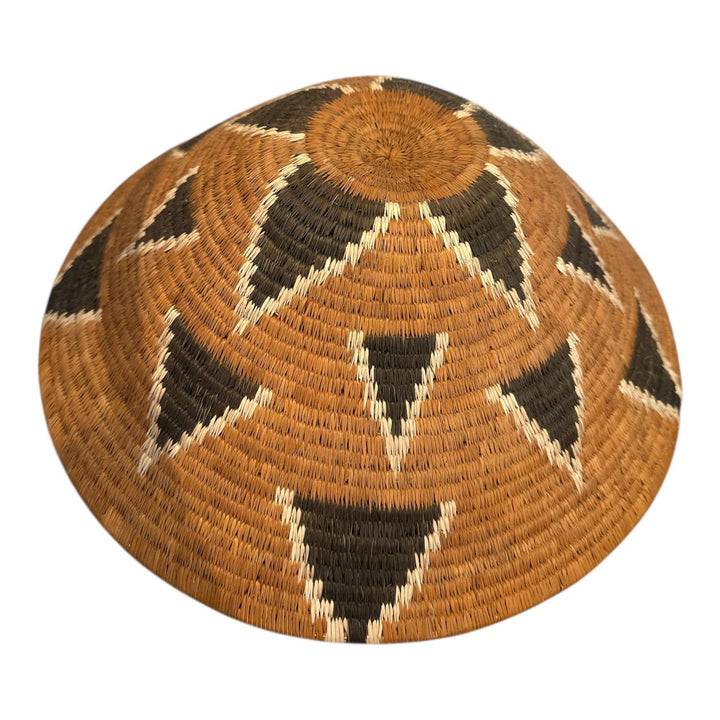 Woven hat with geometric pattern on a white background