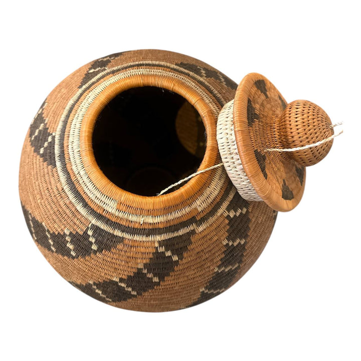 Woven basket with lid on a white background